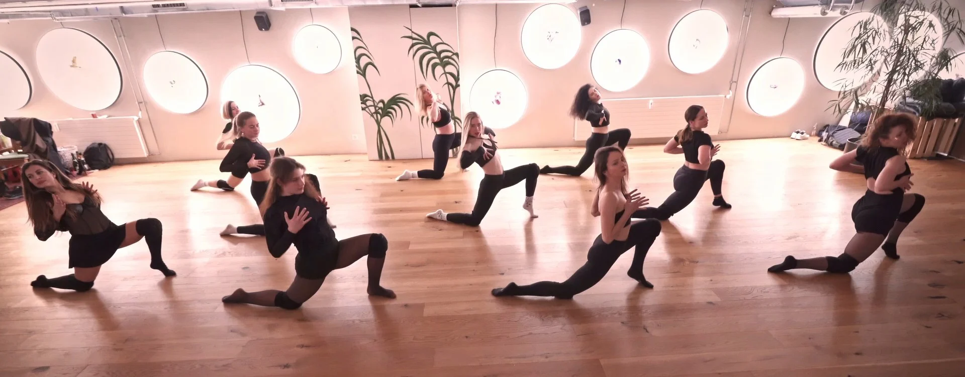 A Floorwork class, everyone in a deep lunge together in the bright Basel studio